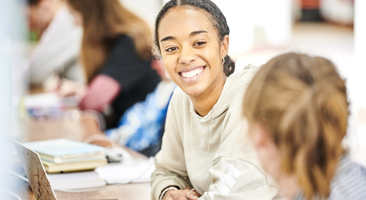 A student smiles while working